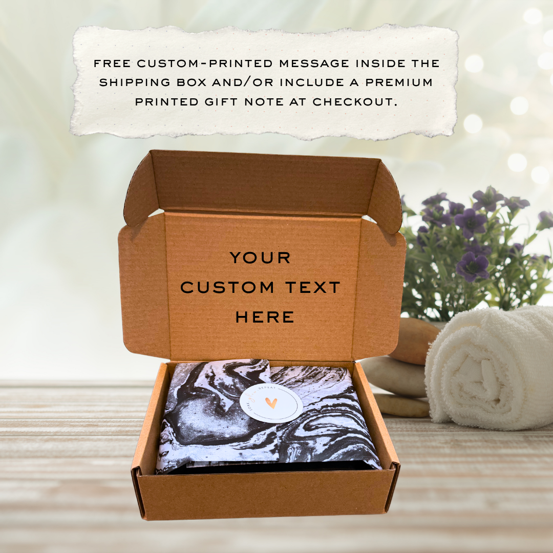 An open cardboard shipping box revealing a wrapped skincare gift set with custom text printed on the inside lid, showcasing a free custom-printed message option for gift orders.